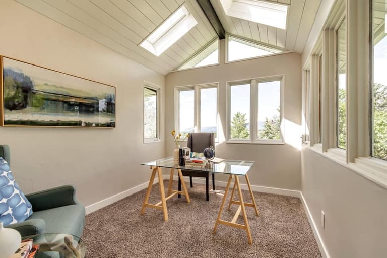 Home office addition with vaulted ceiling, multiple skylights, panoramic windows, and natural Utah views — by CasaMás Construction